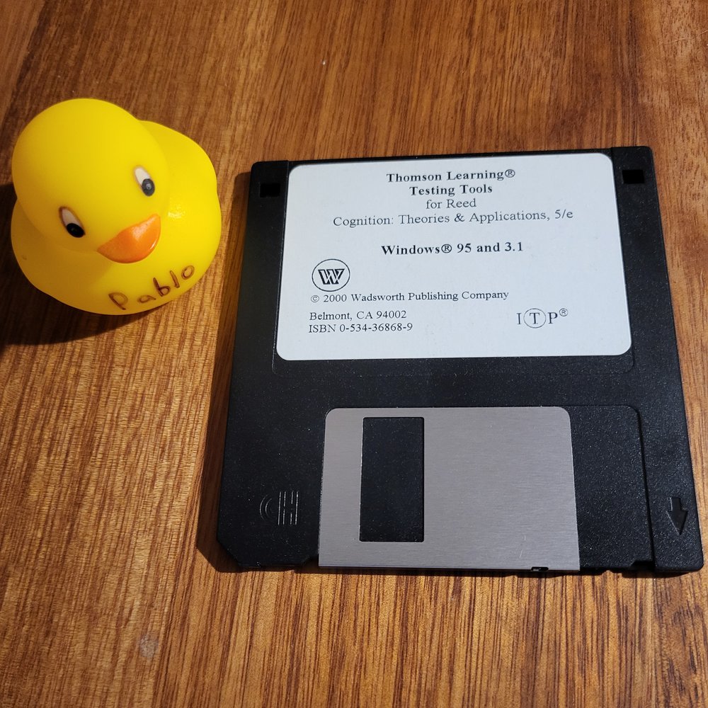 a rubber duck next to a floppy disk